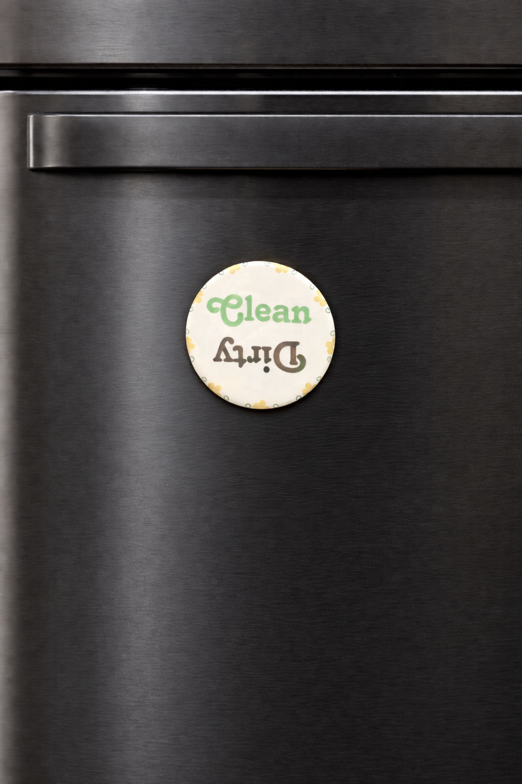 Round 'Clean' and 'Dirty' magnet on a black dishwasher